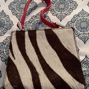A  zebra print fur mini bag.